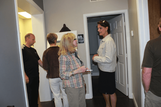 Opening Event Guests Conversing and Signing Signature Board