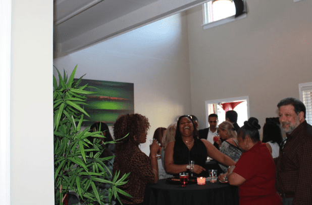 Wideshot of Opening Event Guests Laughing and Conversing