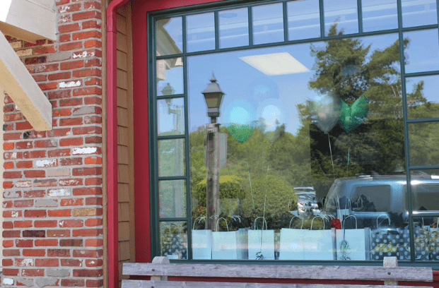 Window Showing Display of Gift Bags and Balloons for Opening Event